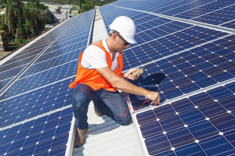 man installing solar panels