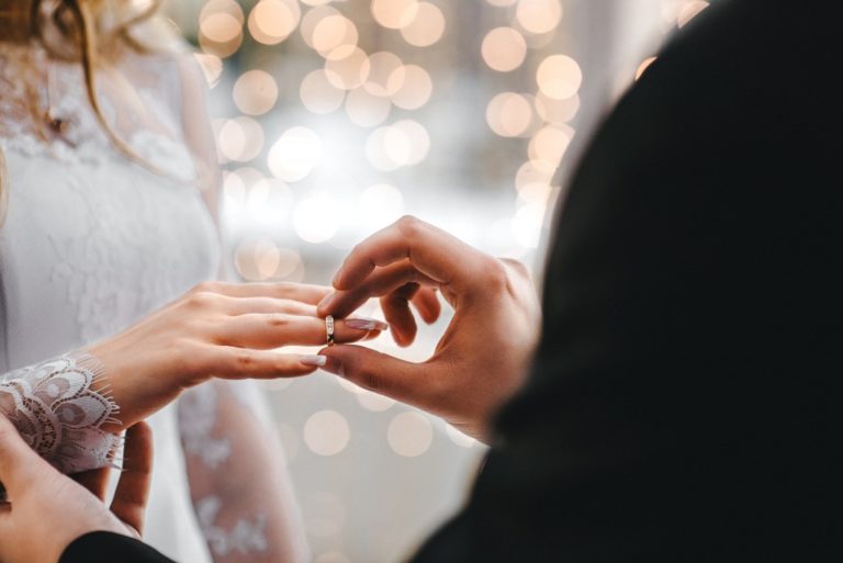 person putting a ring on her partner