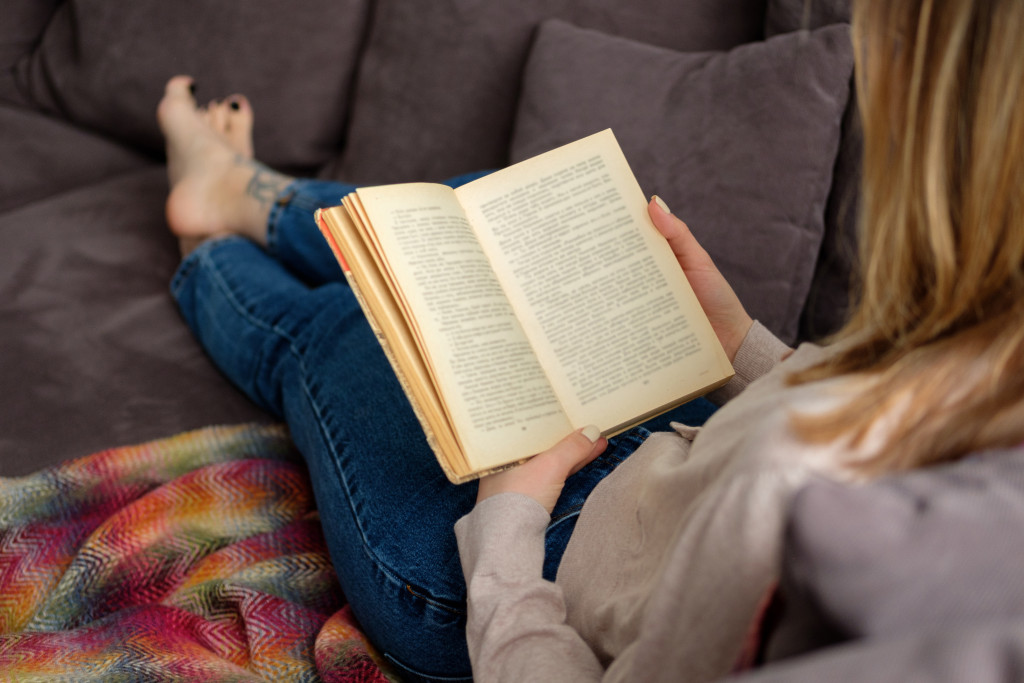 Reading a book on a sofa