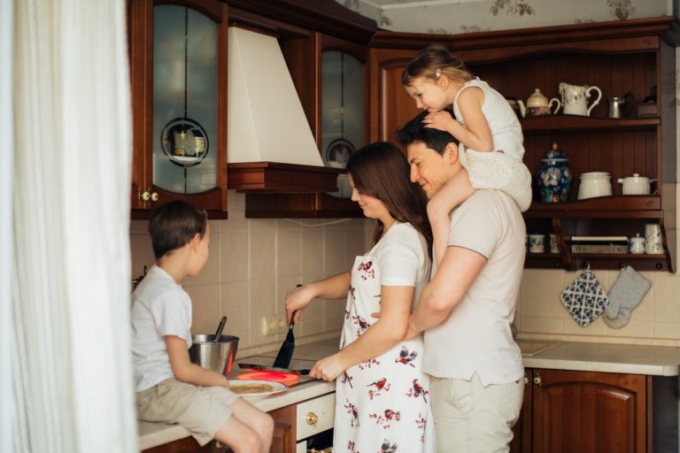 family making breakfast together