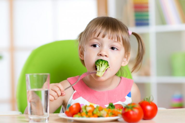 child eating vegetables