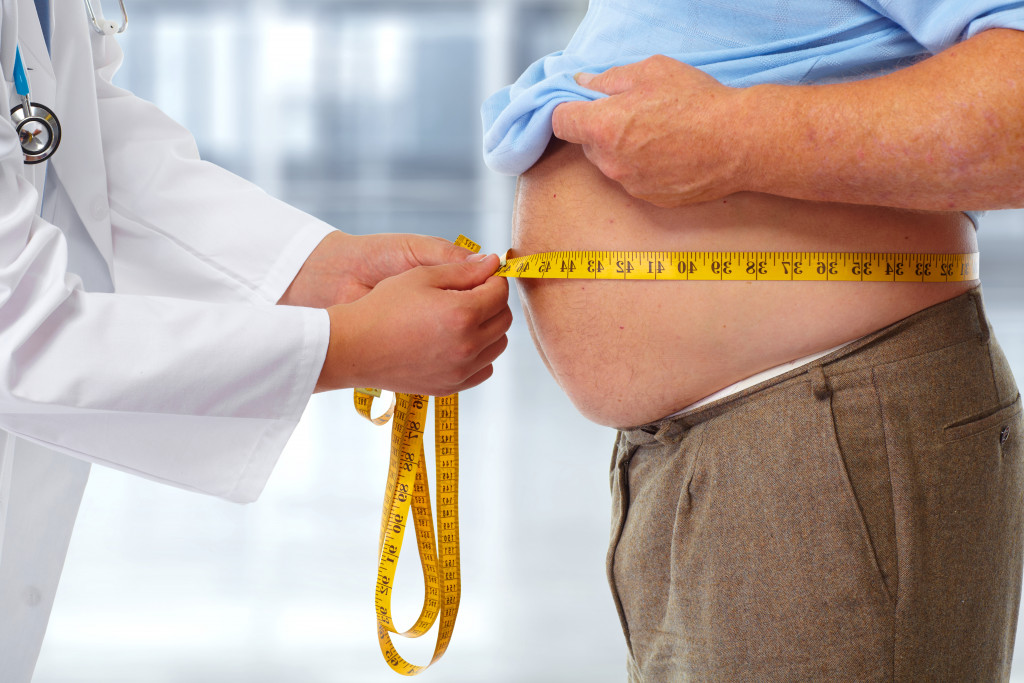 doctor measuring patients belly