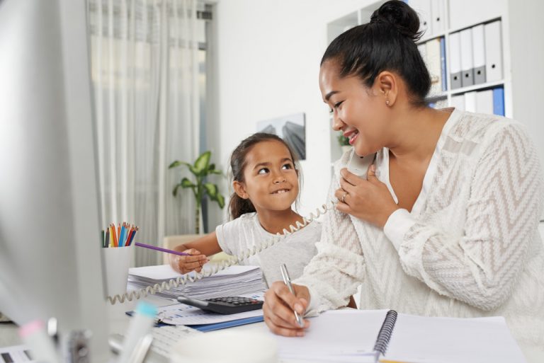 mother working while taking care of kids