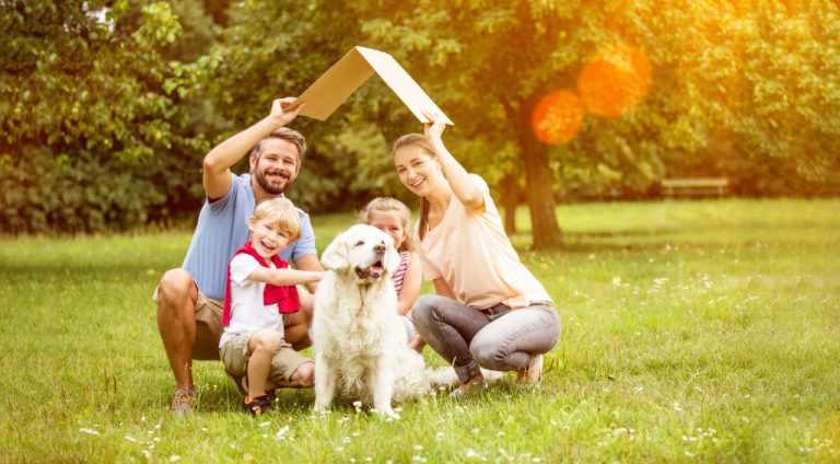 Family with pet dog outside