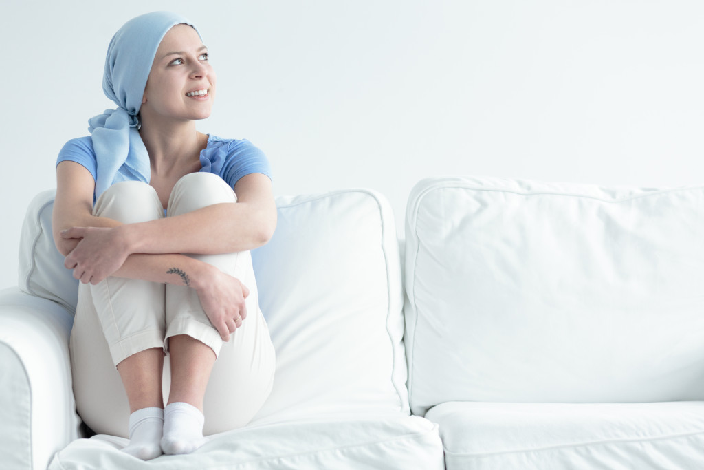 A hopeful cancer patient sitting in a sofa
