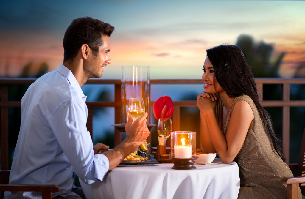 couple having a romantic candlelit dinner on a summer evening