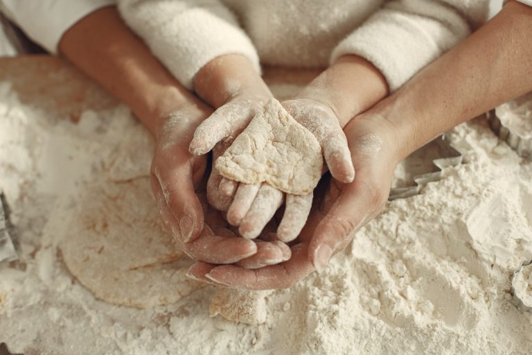 Mother and Child Holding Heart Made of Dough