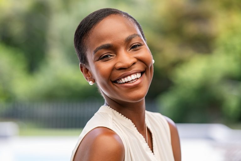 A woman wearing a confident smile