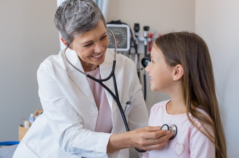 a girl being examined by pediatrician