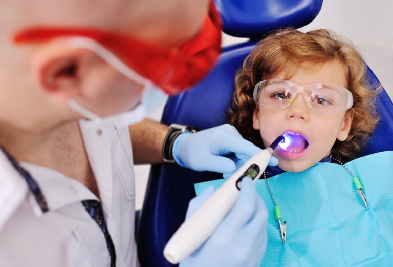 dentist doing check up to child