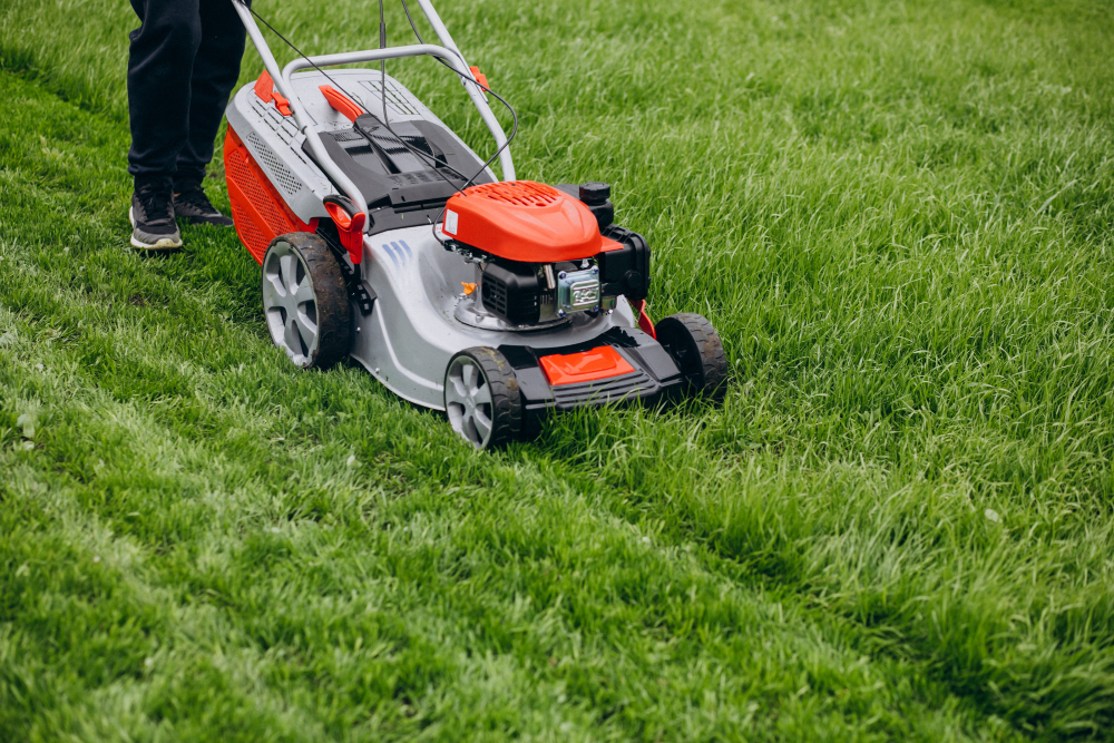 Man cutting grass with lawn mover